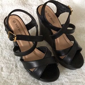 Never worn. Black strap wedges